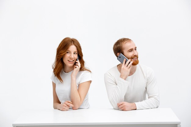 赤毛の女の子とスマートフォンを話している男性