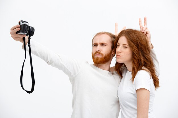 Redhead happy man and woman take selfie