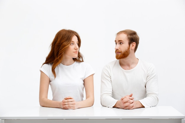 Redhead man and woman look each others eyes