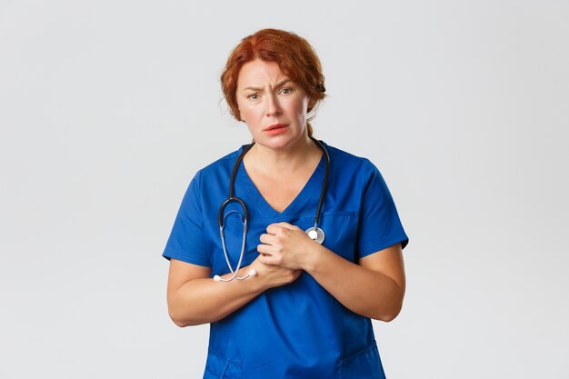 Redhead middle-aged nurse posing