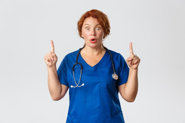 Redhead middle-aged nurse posing