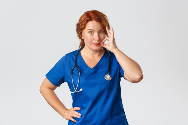 Redhead middle-aged nurse posing