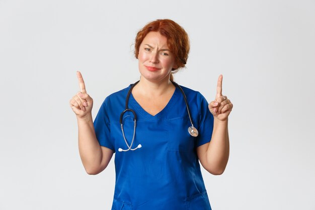 Redhead middle-aged nurse posing