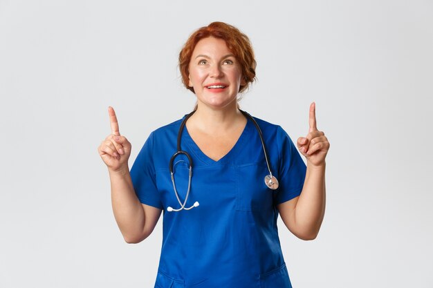 Redhead middle-aged nurse posing