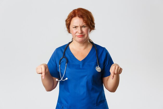 Redhead middle-aged nurse posing