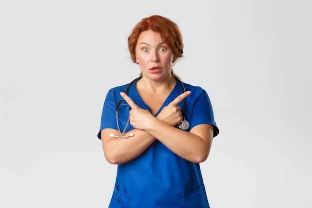 Redhead middle-aged nurse posing