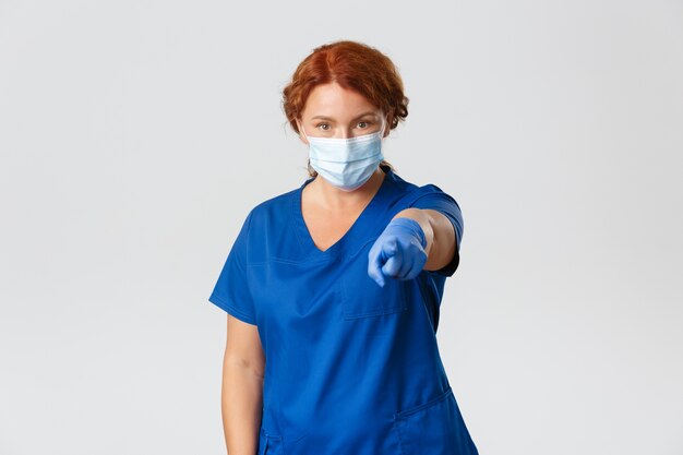 Redhead middle-aged nurse posing