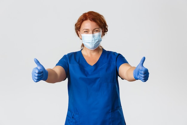 Free photo redhead middle-aged nurse posing