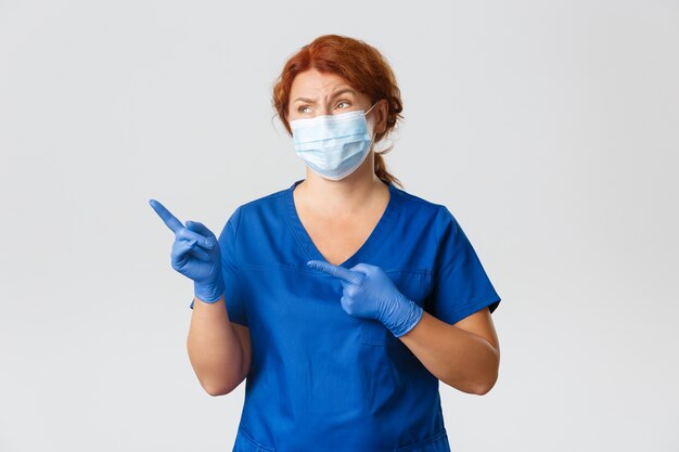 Redhead middle-aged nurse posing