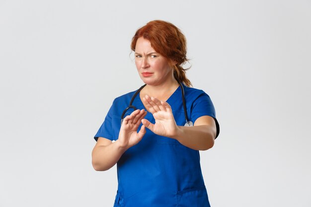 Redhead middle-aged nurse posing