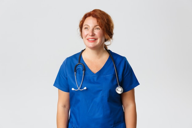 Redhead middle-aged nurse posing