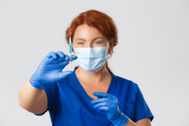 Redhead middle-aged nurse posing