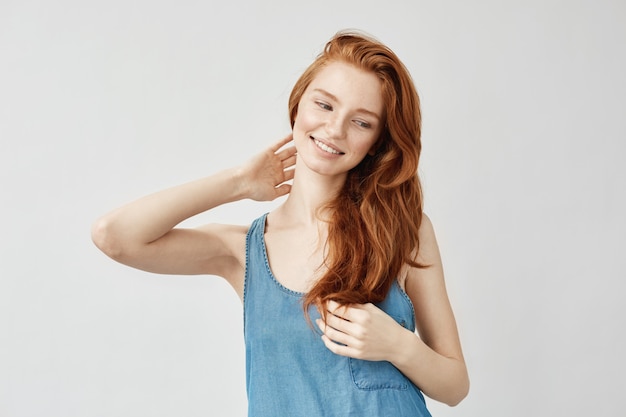 Redhead Model Smiling and Touching Hair – Free Stock Photo