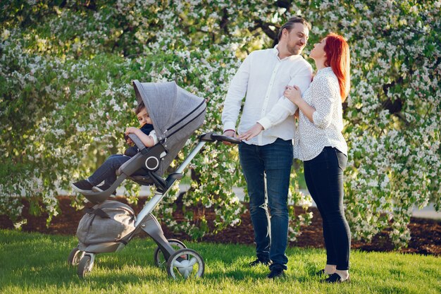  redhead mom in a white blouse wallking with her beautiful man and her son