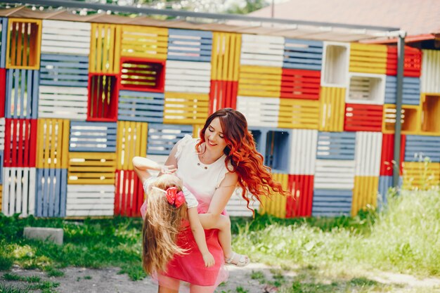 redhead mother and daughter in the park