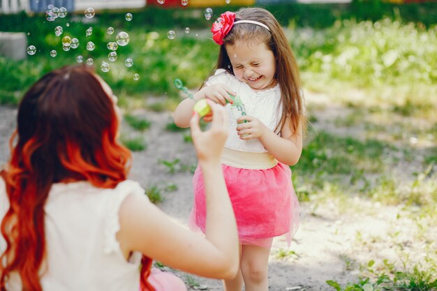 redhead mother and daughter in the park