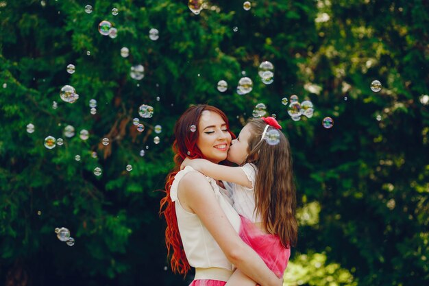 redhead mother and daughter in the park