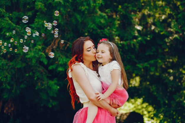 redhead mother and daughter in the park