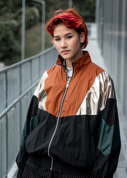 Redhead non binary person wearing sports clothes outside