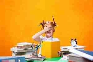 Free photo the redhead teen girl with lot of books at home. studio shot