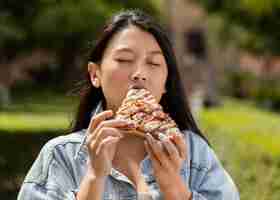 Free photo redhead woman eating some street food