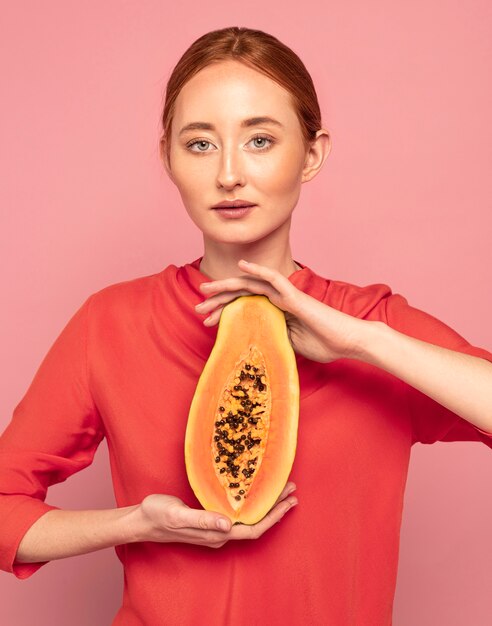 Redhead woman holding a melon