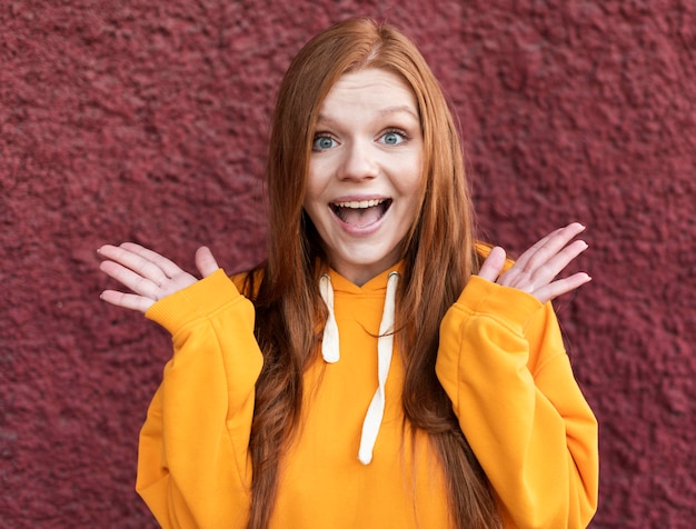 Free photo redhead woman looking surprised