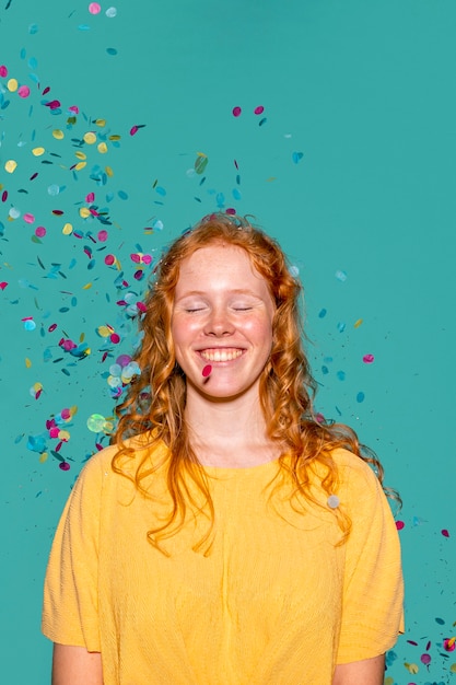 Redhead woman partying with confetti