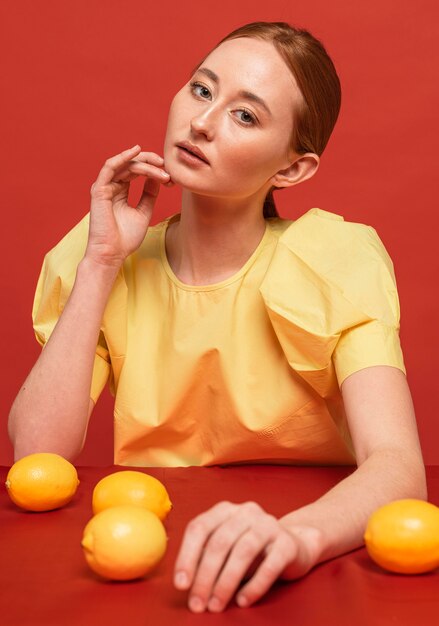 Redhead woman posing with lemons