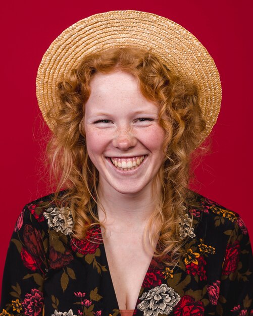 Redhead young female smiling widely at camera