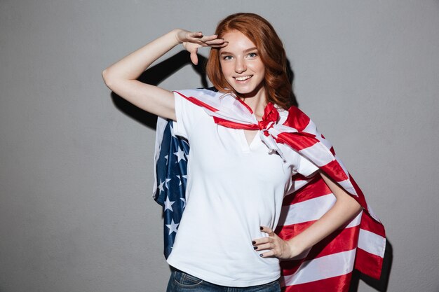 Redhead young lady superhero with USA flag. 