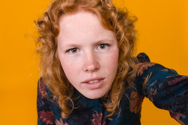 Redhead young woman making selfie