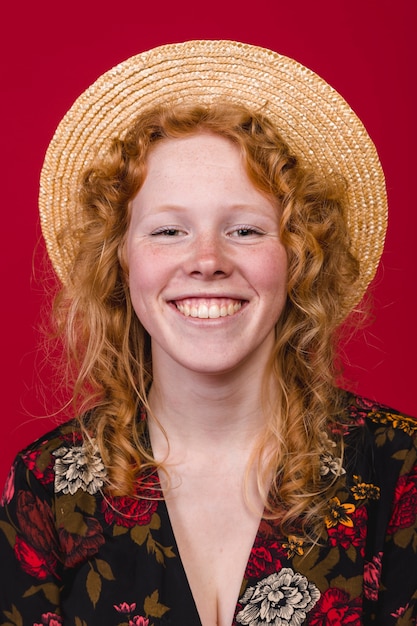 Redhead young woman smiling on burgundy background