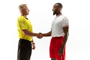 Referee gives directions with gestures to football or soccer players while gaming isolated on white studio background.