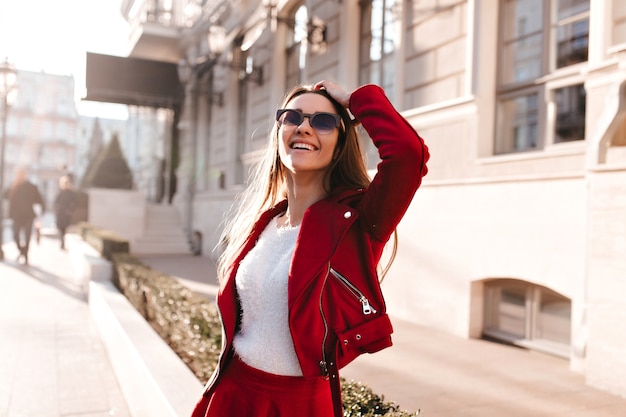 Refined caucasian girl in sunglasses looking up