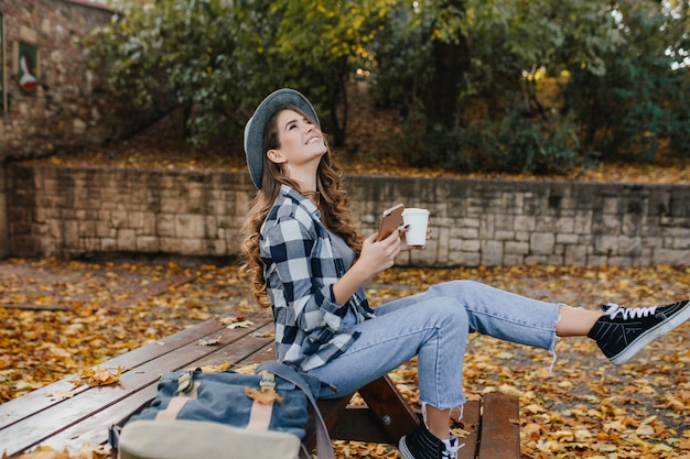 Free Photo refined white woman in stylish casual clothes spending time at countryside in autumn day
