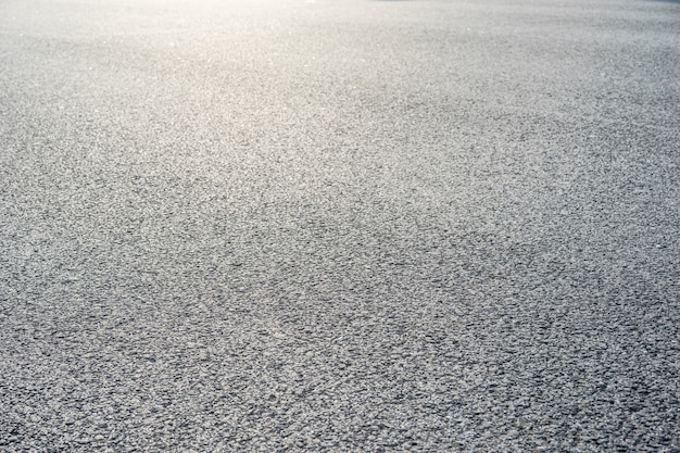 Wet asphalt road after the rain. Asphalt background. Asphalt perspective.  Background and texture. Sun reflection Stock Photo