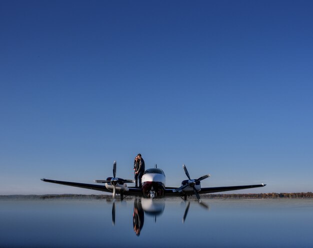 Reflection of a helicopter and a couple in love and blue sky, romantic unforgotten date