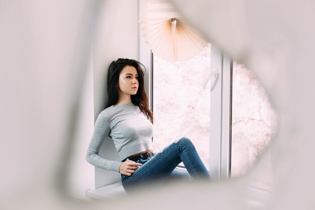 Free Photo reflection of lady on windowsill in the mirror