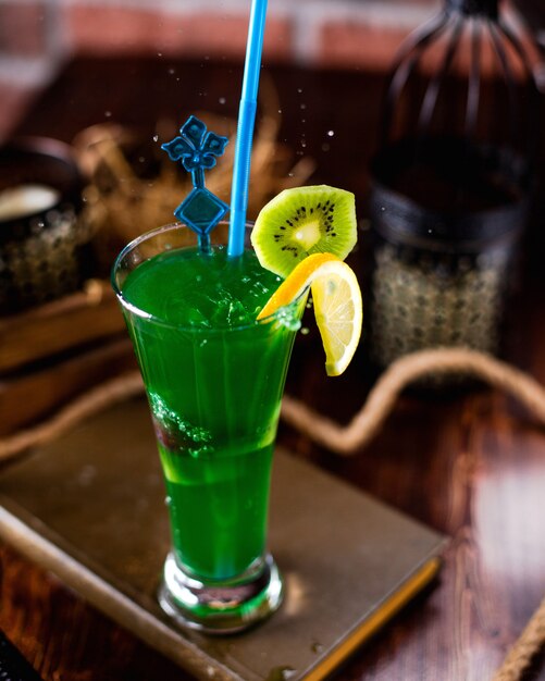 Refreshing cocktail decorated with orange and kiwi slices