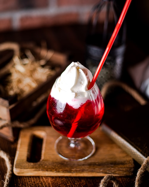 Refreshing cocktail with whipped cream on top