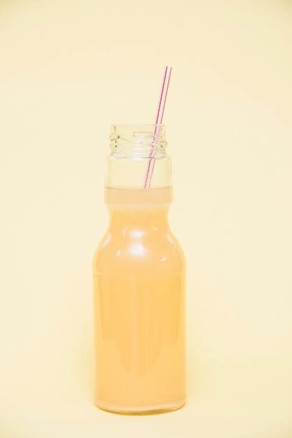 Refreshing drink in bottle with straw