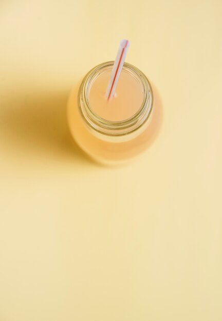 Refreshing drink in bottle with straw