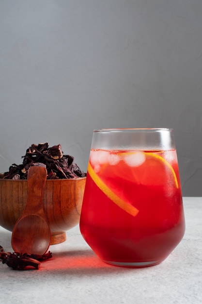 Refreshing hibiscus ice tea in clear glass container