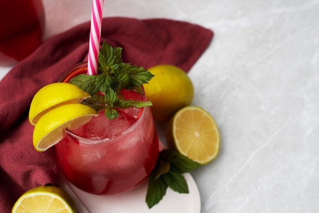 Free photo refreshing hibiscus ice tea in clear glass container