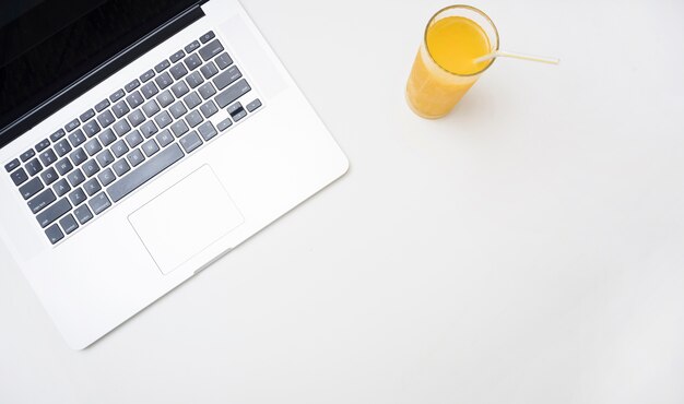 Refreshing orange juice and laptop