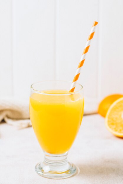 Refreshing orange juice with straw