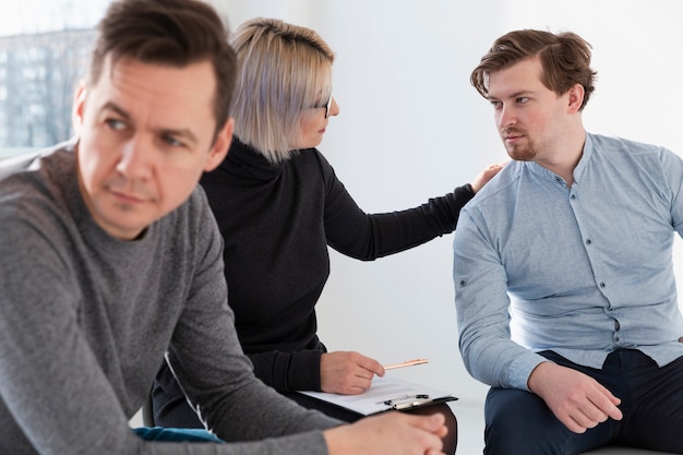 Rehab doctor and male patient looking at each other