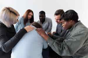 Free photo rehab patients consoling a sad man