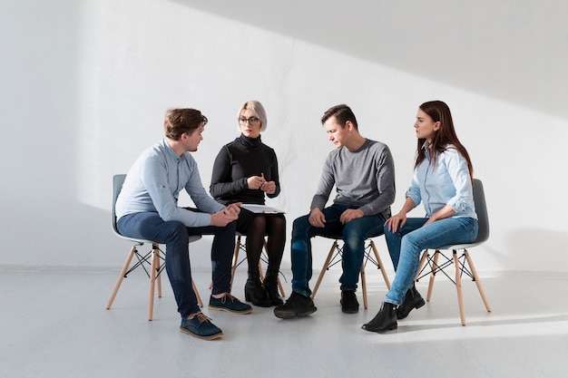 Free photo rehab patients sitting in a  white room